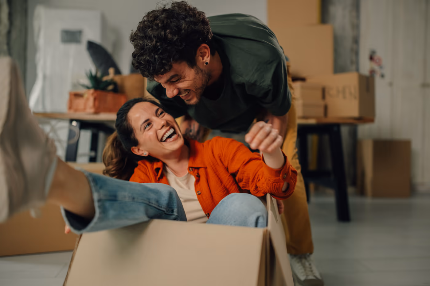 A couple unpacking boxes on moving day in their new home
